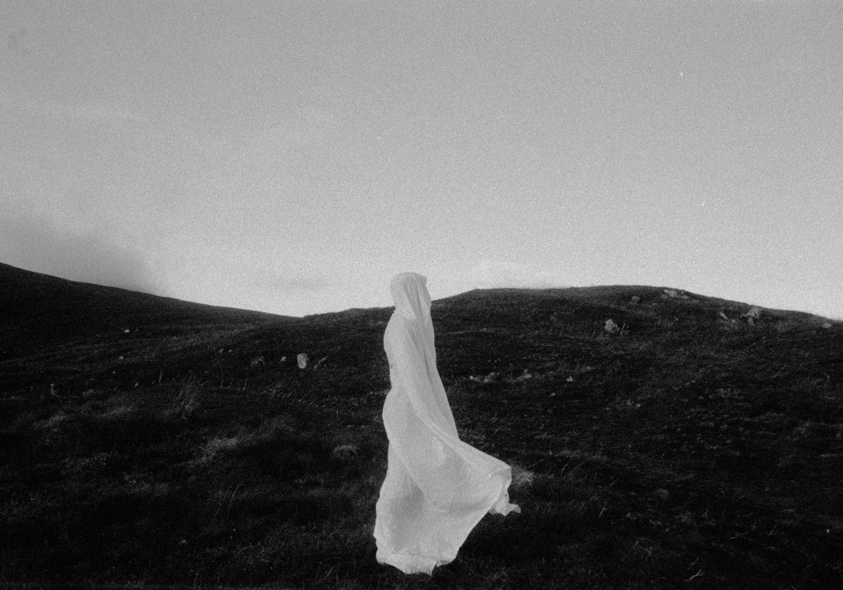 figure in white sheet